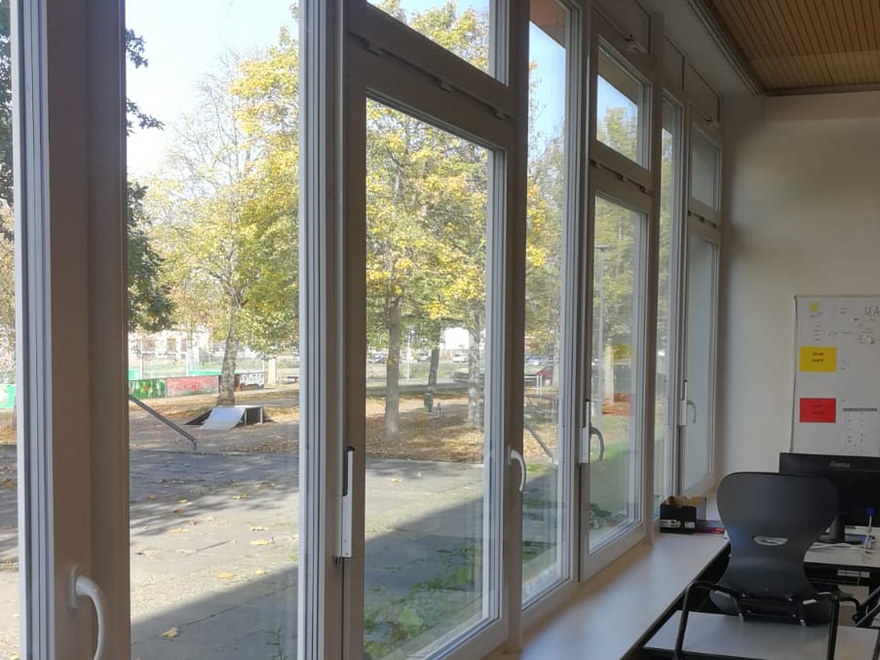 Fensterband aus weißen Kunststofffenstern im Klassenraum, Innenansicht